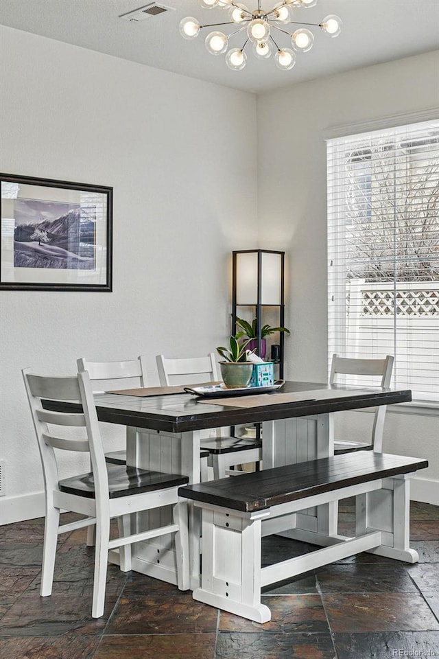 11307 Navajo Cir Unit A, Westminster, CO 80234 - dining space featuring a chandelier and stone finish floors