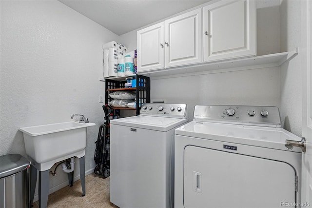 11307 Navajo Cir Unit A, Westminster, CO 80234 - laundry room featuring cabinet space, washing machine and dryer, and light tile patterned floors