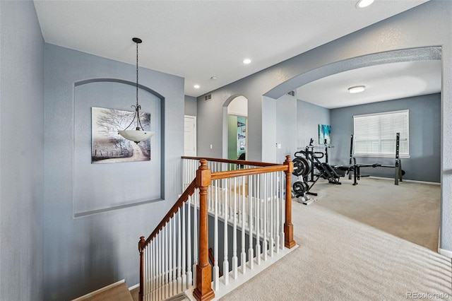 11307 Navajo Cir Unit A, Westminster, CO 80234 - hallway with carpet flooring, arched walkways, an upstairs landing, and recessed lighting