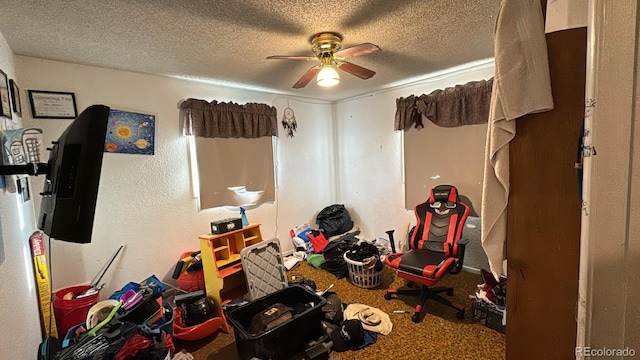 interior space with ceiling fan and a textured ceiling