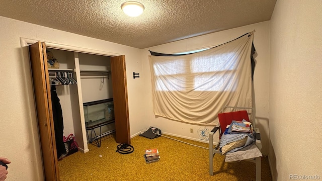 carpeted bedroom featuring a closet and a textured ceiling