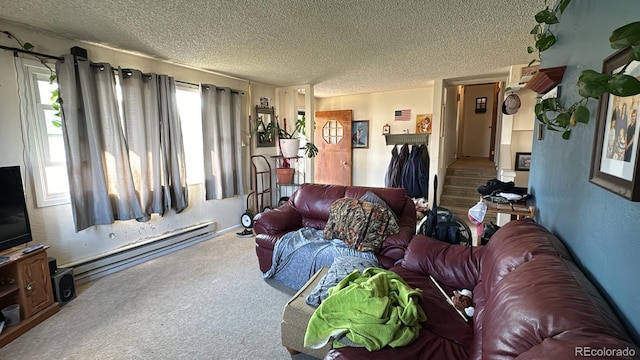 living room featuring baseboard heating, a textured ceiling, carpet floors, and a wealth of natural light