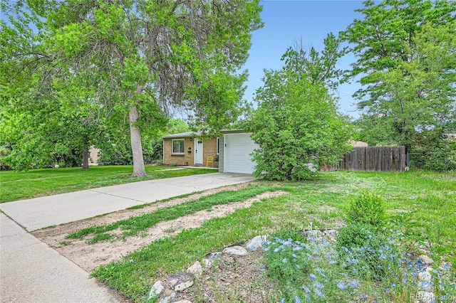 view of front of property featuring a garage and a front lawn