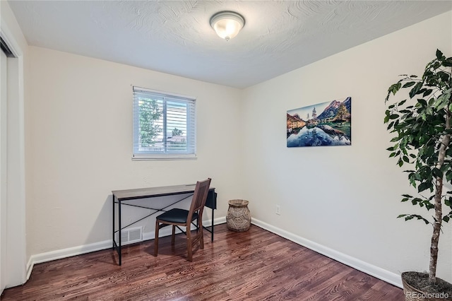 office area featuring a textured ceiling and dark hardwood / wood-style flooring