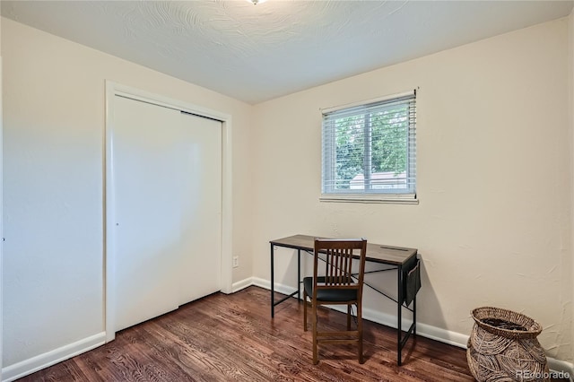 home office with dark wood-type flooring