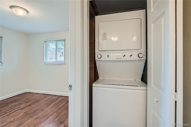 laundry area with hardwood / wood-style flooring and stacked washer and dryer