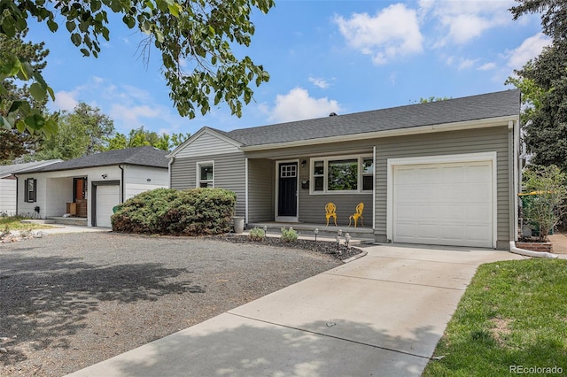 1920 Elmira St, Aurora, CO 80010 - ranch-style house with an attached garage, concrete driveway, covered porch, and a shingled roof