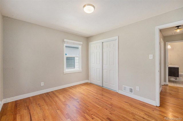 1920 Elmira St, Aurora, CO 80010 - unfurnished bedroom featuring light wood-style flooring and a closet