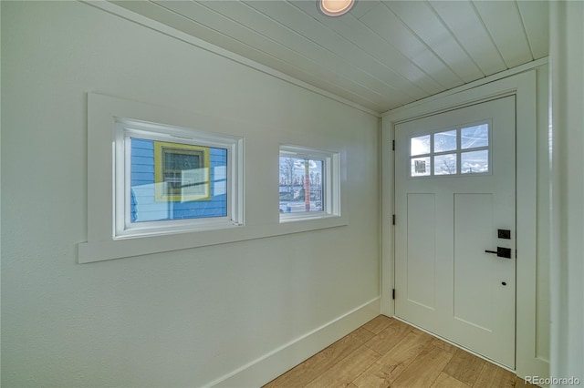 doorway with lofted ceiling and light hardwood / wood-style flooring