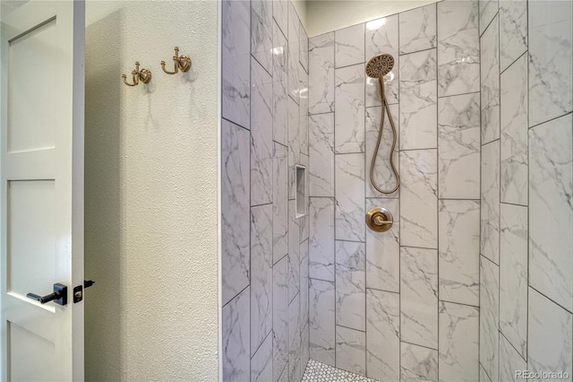 bathroom with tiled shower