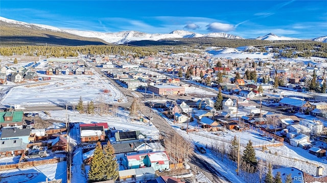 snowy aerial view featuring a mountain view