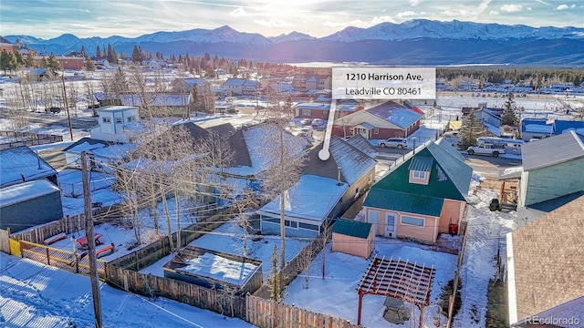 snowy aerial view with a mountain view