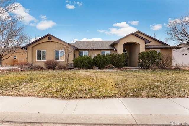 single story home featuring a front lawn