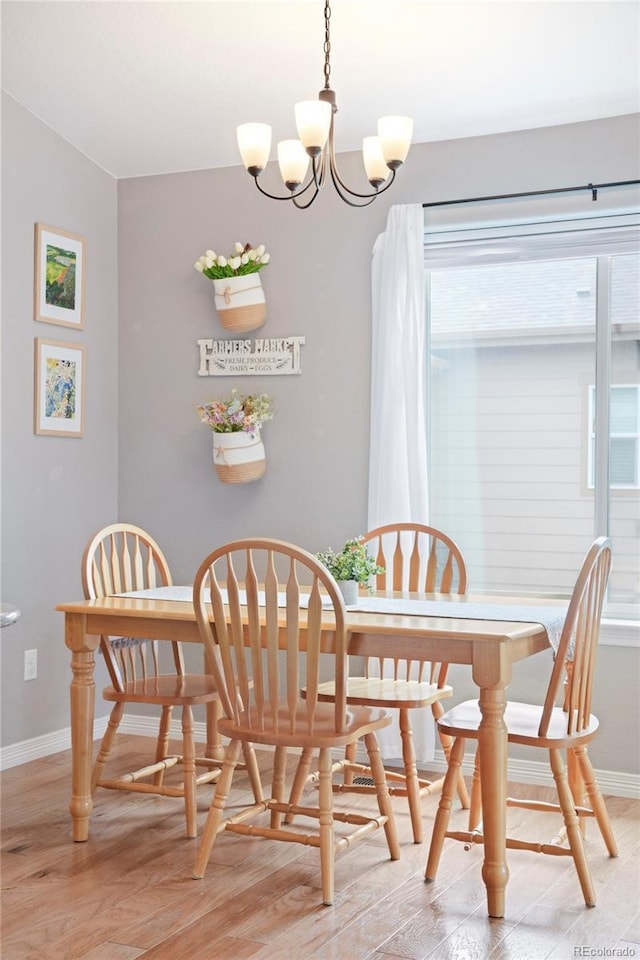 577 Tristan Pl, Berthoud, CO 80513 - dining area featuring baseboards, a chandelier, and light wood-style flooring