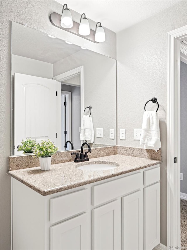 577 Tristan Pl, Berthoud, CO 80513 - bathroom with vanity and a textured wall