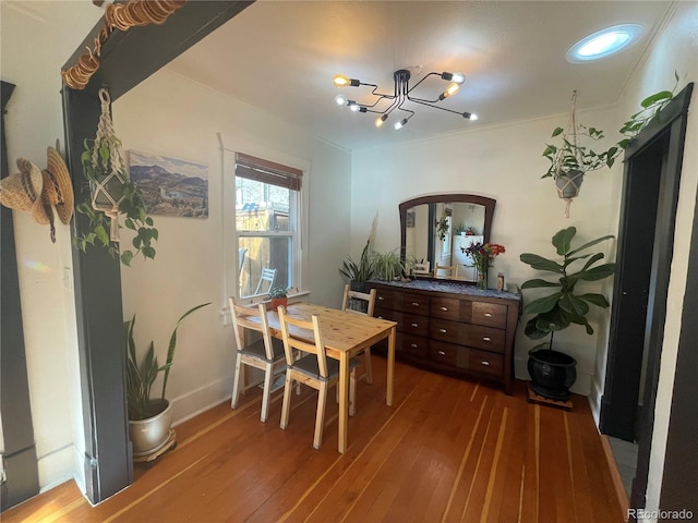 dining area featuring hardwood / wood-style floors and a notable chandelier