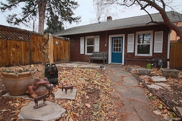 back of property with a patio