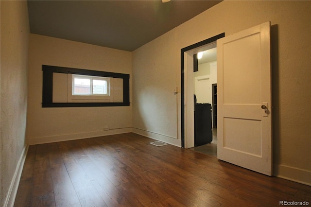 spare room featuring dark hardwood / wood-style flooring