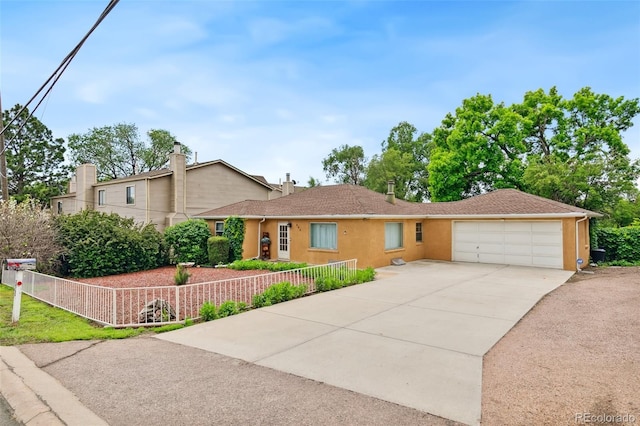 305 W Brookside St, Colorado Springs, CO 80905 - view of front of house featuring driveway, a garage, and stucco siding