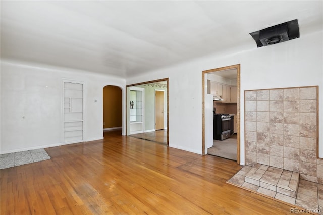305 W Brookside St, Colorado Springs, CO 80905 - unfurnished bedroom with arched walkways and wood finished floors