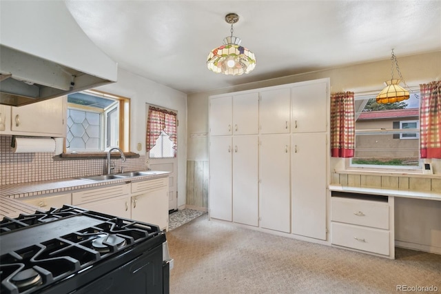 305 W Brookside St, Colorado Springs, CO 80905 - kitchen featuring black gas range oven, pendant lighting, white cabinetry, light countertops, and custom exhaust hood