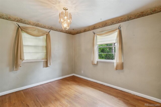 305 W Brookside St, Colorado Springs, CO 80905 - unfurnished room featuring wood finished floors and a chandelier