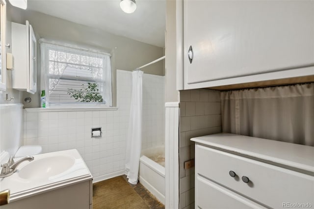 305 W Brookside St, Colorado Springs, CO 80905 - bathroom featuring tile walls, vanity, shower / bath combination with curtain, and a wainscoted wall