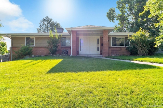 7930 S Kendall Ct, Littleton, CO 80128 - view of front of home with brick siding and a front yard