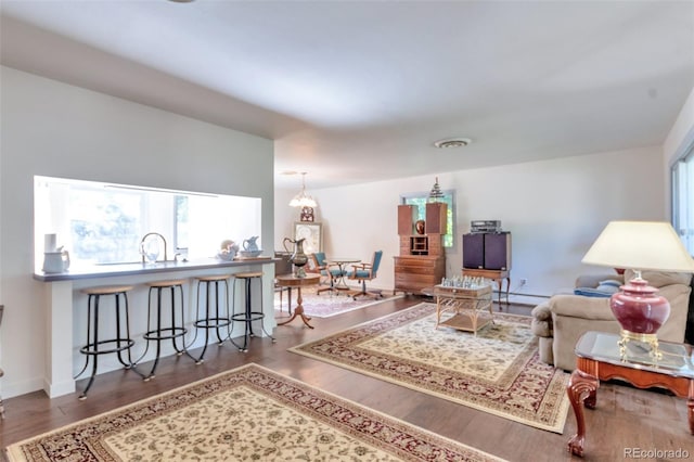 7930 S Kendall Ct, Littleton, CO 80128 - living room with wood finished floors and a baseboard heating unit