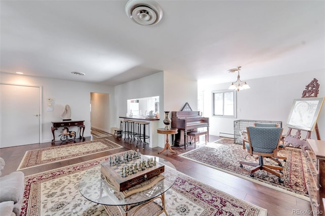 7930 S Kendall Ct, Littleton, CO 80128 - living room with a baseboard heating unit, a chandelier, and wood finished floors