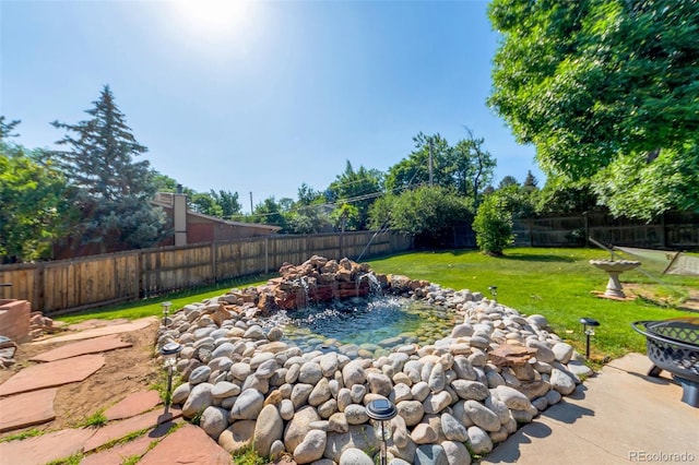 7930 S Kendall Ct, Littleton, CO 80128 - fenced backyard with a garden pond