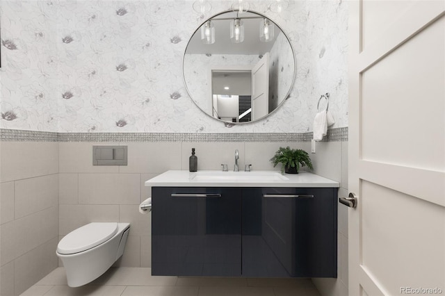 bathroom with vanity, tile walls, tile patterned floors, and toilet