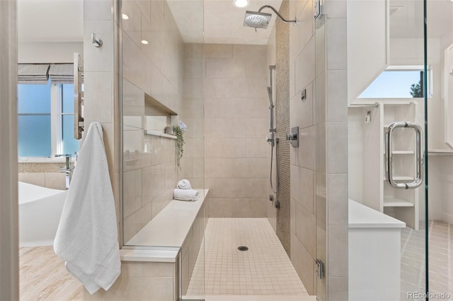 bathroom featuring a shower with door