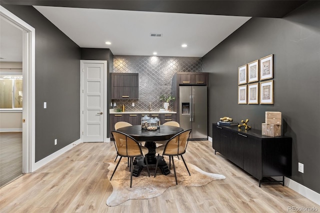 dining space with light hardwood / wood-style flooring