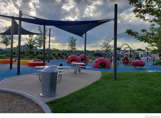 view of property's community with a playground and a yard