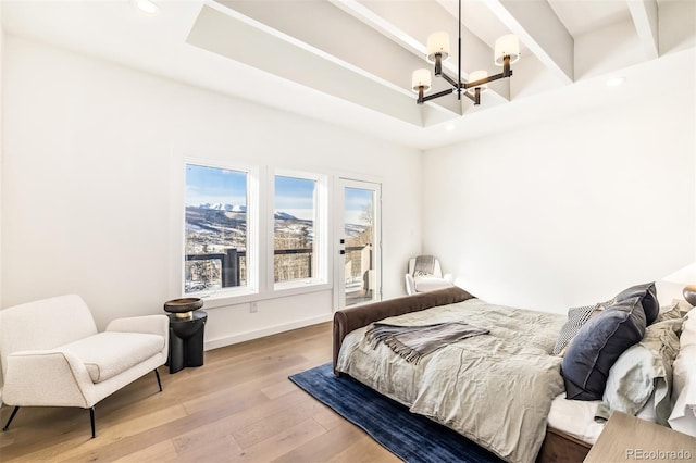 bedroom with a notable chandelier and wood-type flooring