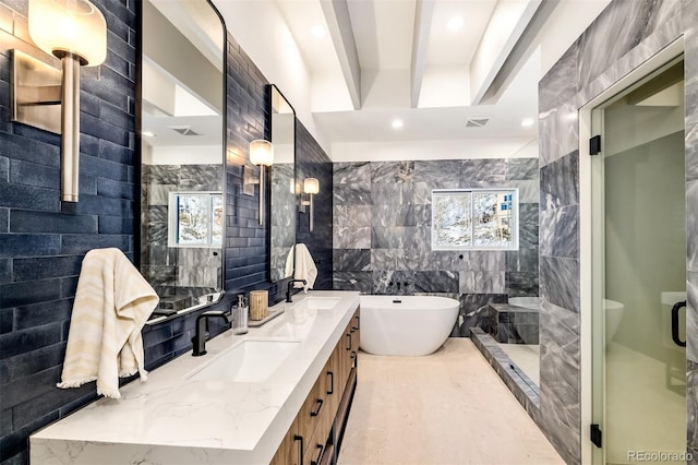 bathroom featuring vanity, tile walls, and separate shower and tub