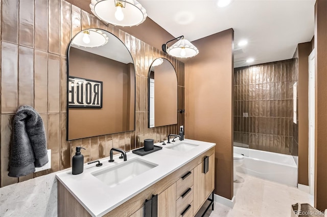 full bathroom with vanity, tiled shower / bath combo, and toilet