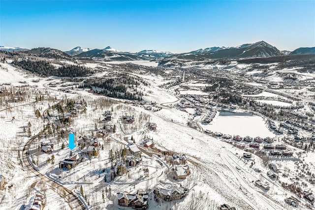 snowy aerial view featuring a mountain view