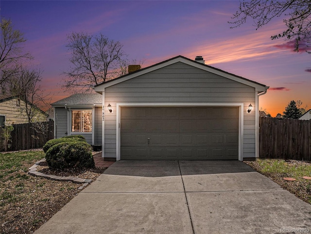 ranch-style home with an attached garage, fence, driveway, and a chimney