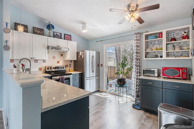 kitchen featuring a textured ceiling, appliances with stainless steel finishes, light wood-type flooring, lofted ceiling, and under cabinet range hood