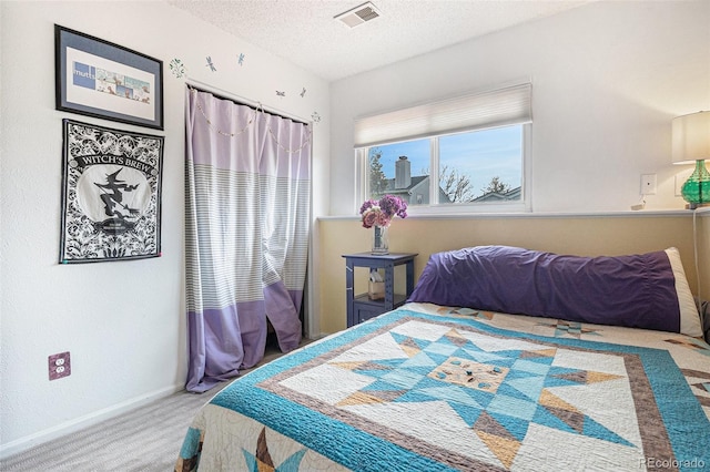 bedroom featuring baseboards, carpet flooring, a textured ceiling, and visible vents