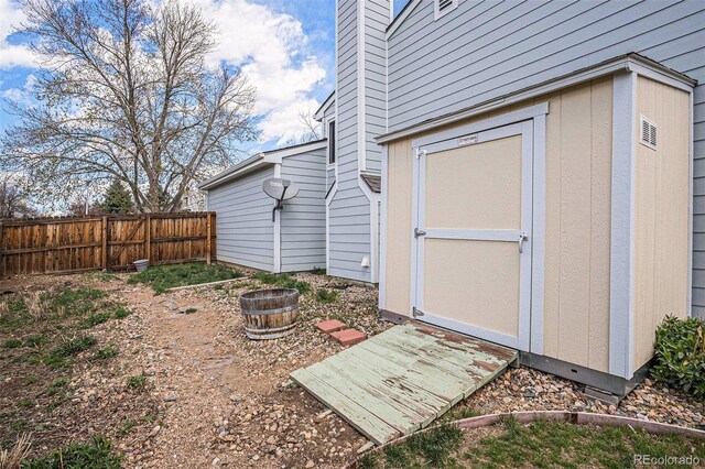 view of shed featuring fence