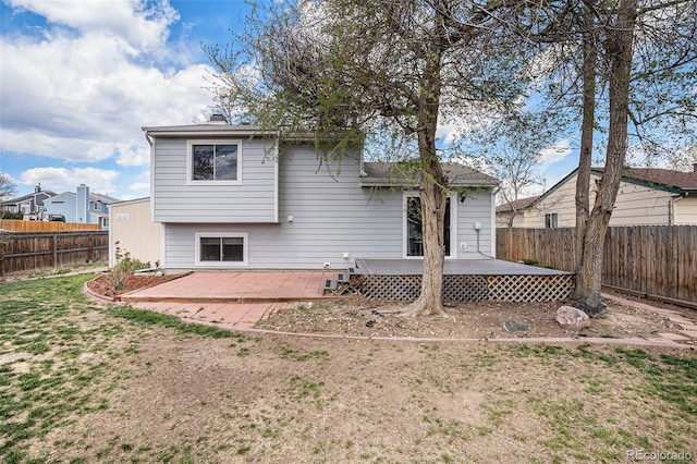 back of house featuring a fenced backyard and a deck