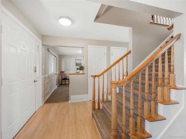 entrance foyer with stairs and wood finished floors