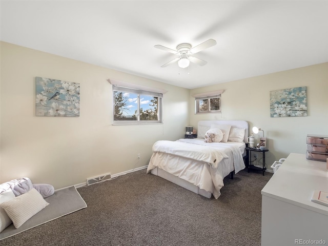 bedroom featuring a ceiling fan, baseboards, visible vents, and dark carpet
