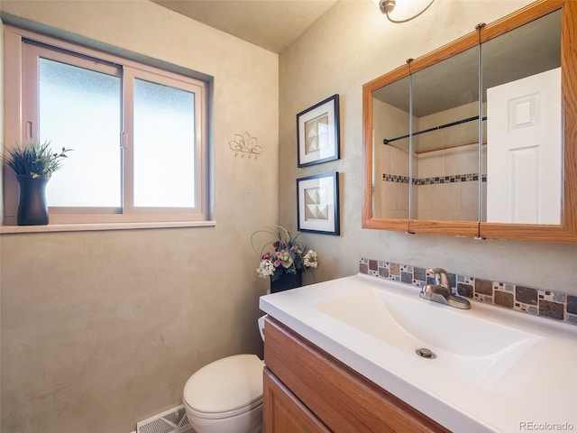 bathroom featuring toilet, visible vents, and vanity