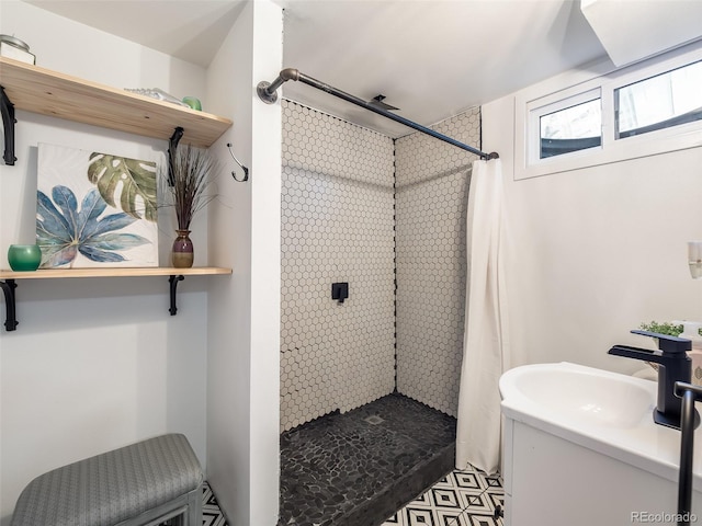 bathroom with a sink and a stall shower