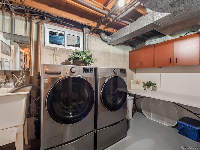 washroom featuring washer and dryer and a sink