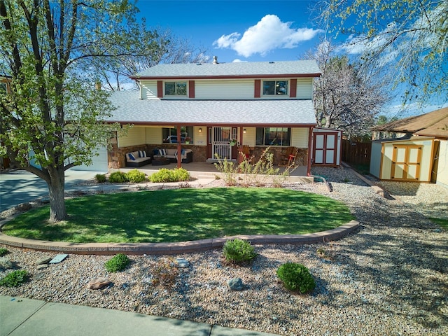 view of front of property with an outdoor structure, covered porch, a front yard, an outdoor hangout area, and a storage shed